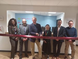 People gathered around to cut the ribbon to open 168 Parklands Medical Centre.