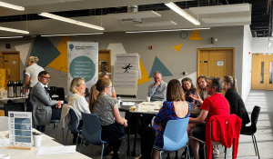 Delegates around a table having a conversation at an event.